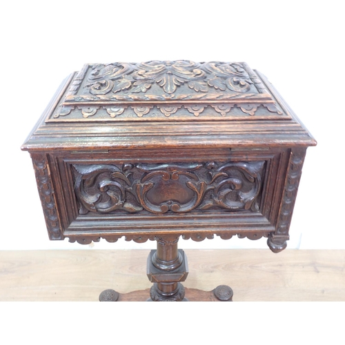 5 - A 19th Century oak Teapoy with carved green man and leafage design 2ft 8in H x 1ft 5in W