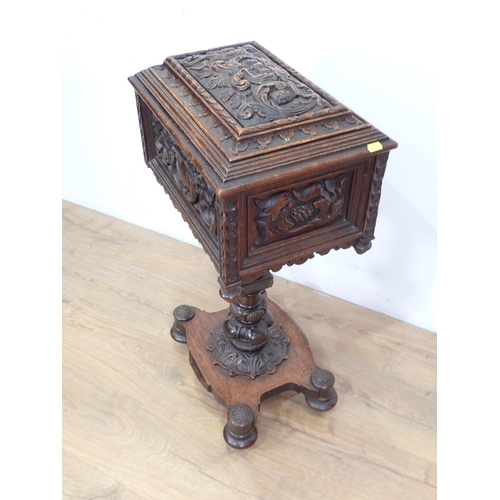 5 - A 19th Century oak Teapoy with carved green man and leafage design 2ft 8in H x 1ft 5in W