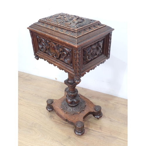 5 - A 19th Century oak Teapoy with carved green man and leafage design 2ft 8in H x 1ft 5in W