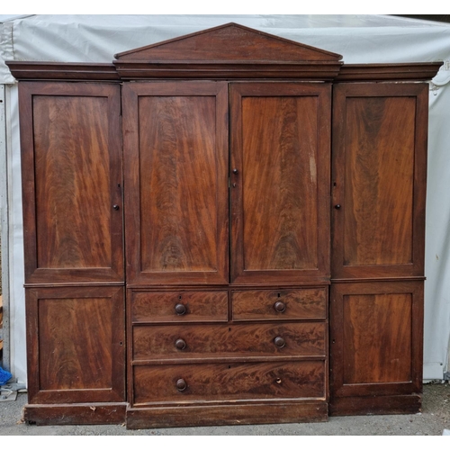 810 - A Victorian mahogany breakfront four door Wardrobe fitted to short and two long drawers to central s... 