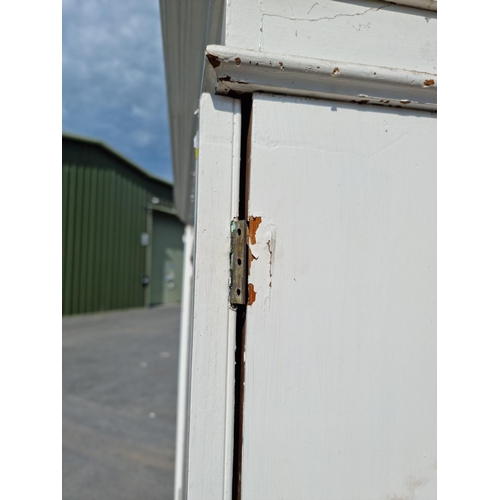 818 - A painted oak Linen Cupboard with two doors above two short and two long drawers 6ft 10ins H x 4ft 2... 