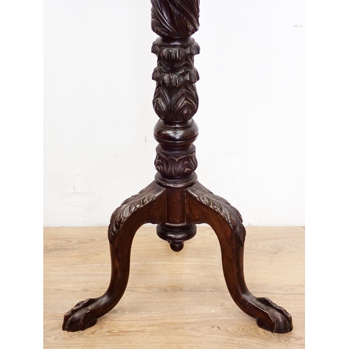 88 - A carved mahogany Torchere on claw and ball feet 4ft 5in H