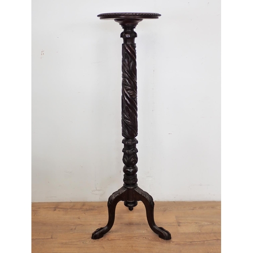 88 - A carved mahogany Torchere on claw and ball feet 4ft 5in H