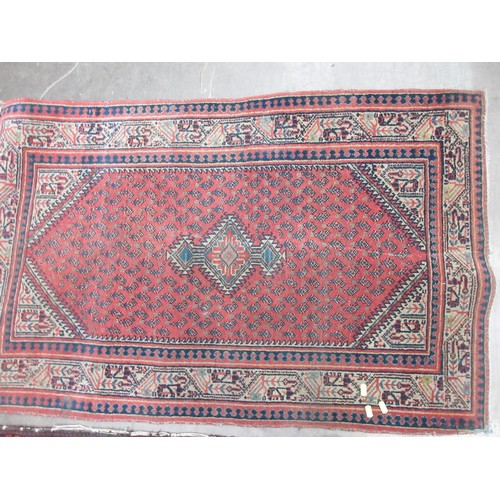 3 - A red ground Persian Rug (heavily worn) 6ft 2in L x 3ft 3in W and a small pink Rug 4ft 1in L x 2ft 5... 