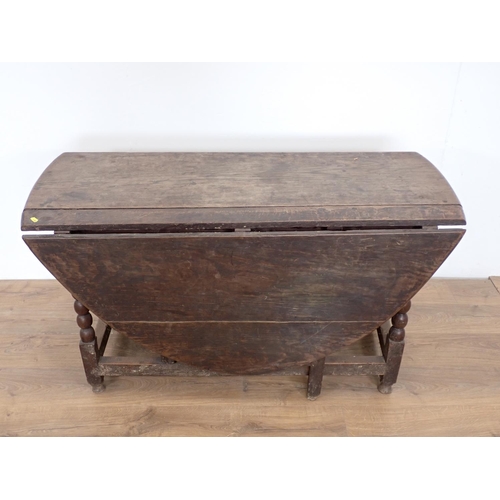 101 - An antique oak Gateleg Table mounted on bobbin turned supports 4ft 1in W x 2ft 5in H