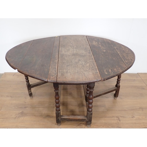 101 - An antique oak Gateleg Table mounted on bobbin turned supports 4ft 1in W x 2ft 5in H