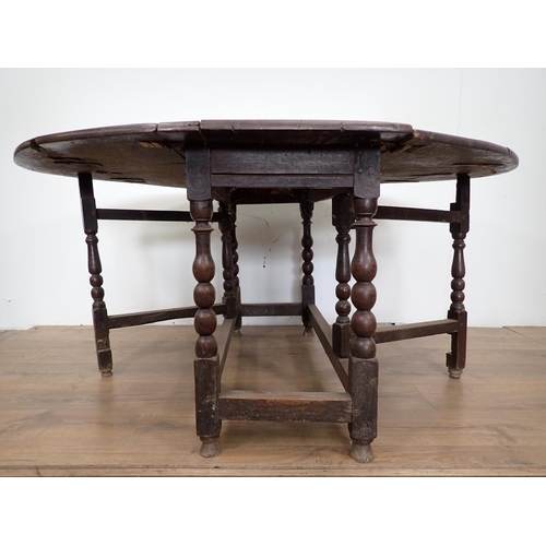 101 - An antique oak Gateleg Table mounted on bobbin turned supports 4ft 1in W x 2ft 5in H