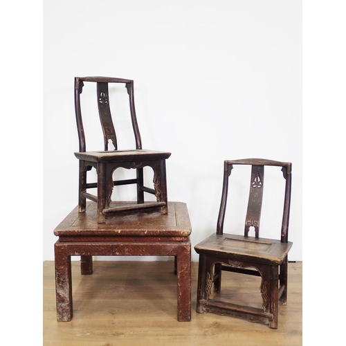 114 - A pair of Chinese elm low Chairs with pierced slat backs 2ft 5in H and a Coffee Table 2ft W x 1ft 7i... 