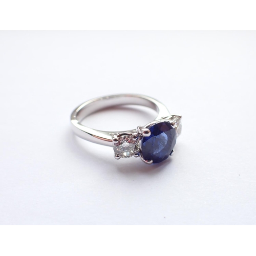 153 - A Sapphire and Diamond three stone Ring claw-set oval-cut sapphire, 1.53cts, between two brilliant-c... 