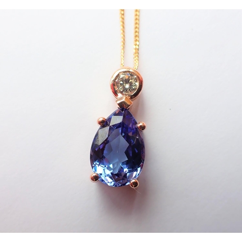 154 - A Diamond and Tanzanite Pendant rubover-set brilliant-cut diamond above claw-set pear-cut tanzanite,... 