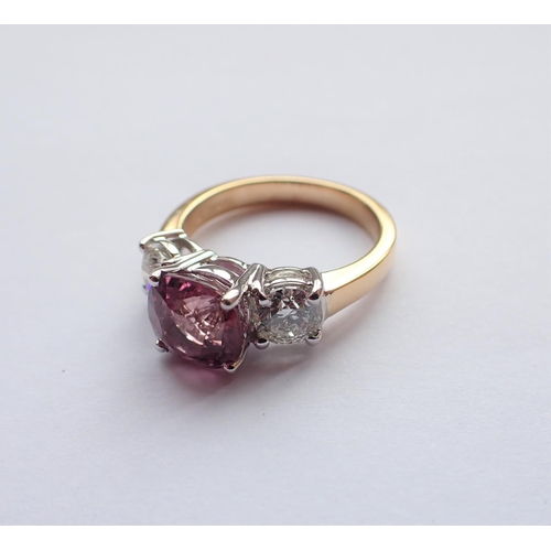 159 - A Pink Sapphire and Diamond three stone Ring claw-set round pink sapphire 2.93cts, between two brill... 