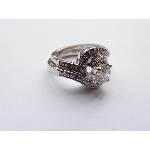 176 - A contemporary Diamond crossover Ring claw-set brilliant-cut stone, 1.00ct, with numerous stones pav... 