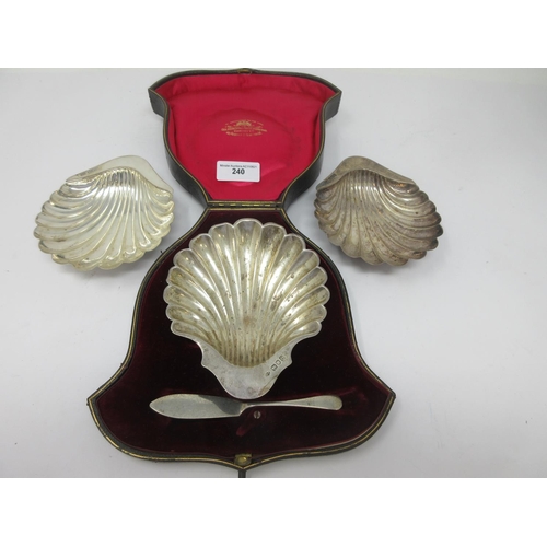 240 - A pair of Edward VII silver Butter Shells, Sheffield 1909, and another, London 1909, cased, with a K... 