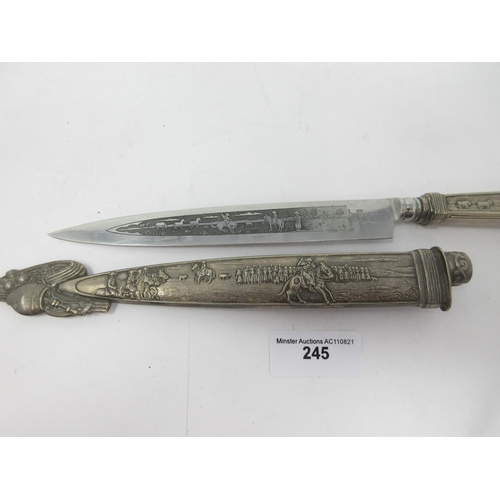 245 - A Mexican style Dagger and Scabbard, the watered steel blade with figures and horses, similar design... 