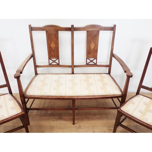 29 - An Edwardian mahogany and inlaid Salon Suite comprising Settee and four single Chairs