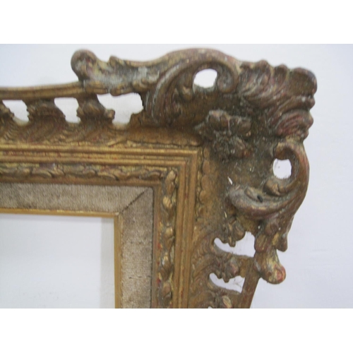 323 - A pierced and decorated gilt and swept frame with slip rebate, 28 x 32in