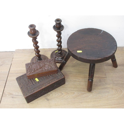 380 - An antique elm Stool, a pair of wooden barley twist Candlesticks and two carved wooden Boxes