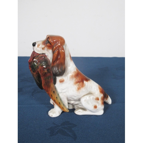 444 - A Royal Doulton figure of seated Spaniel holding a pheasant in mouth