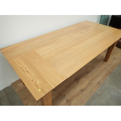 486 - A modern oak Dining Table on square cut tapering supports 7ft L x 2ft 5in H