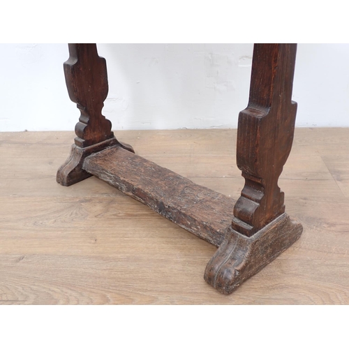 492 - An antique oak dropleaf Table incorporating early timbers on later urn shaped silhouette end support... 