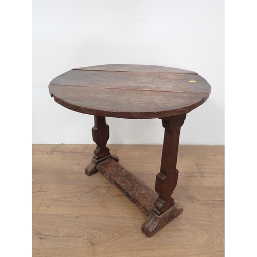 492 - An antique oak dropleaf Table incorporating early timbers on later urn shaped silhouette end support... 