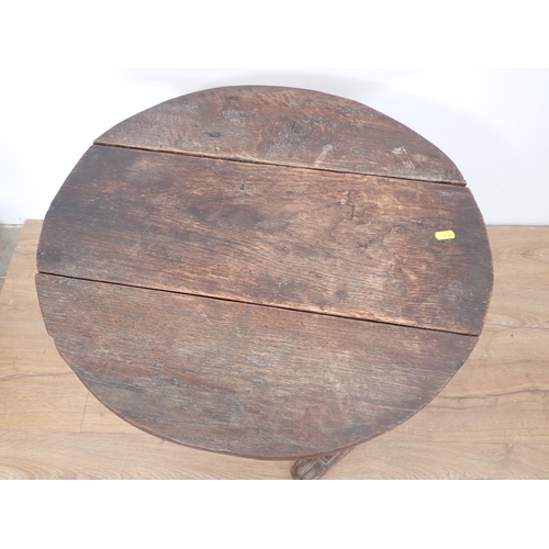 492 - An antique oak dropleaf Table incorporating early timbers on later urn shaped silhouette end support... 