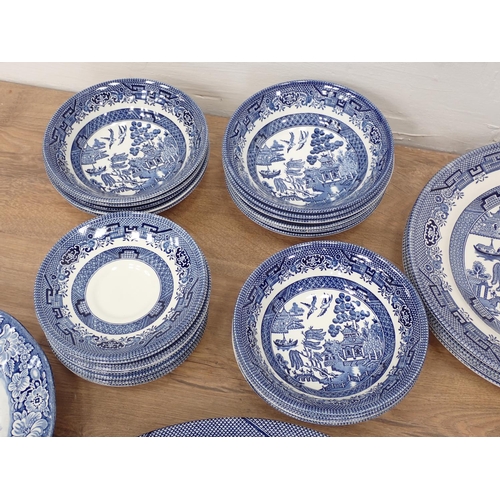 501 - A quantity of willow pattern China, a pair of squat blue glass Candlesticks, glass Knife Rests etc a... 