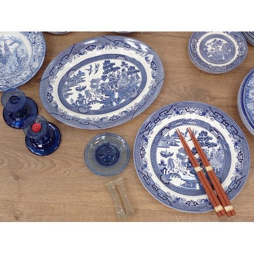 501 - A quantity of willow pattern China, a pair of squat blue glass Candlesticks, glass Knife Rests etc a... 