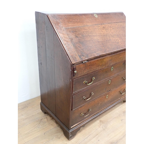 503 - An 18th Century oak Bureau, the interior fitted drawers, pigeon holes and well above three long draw... 