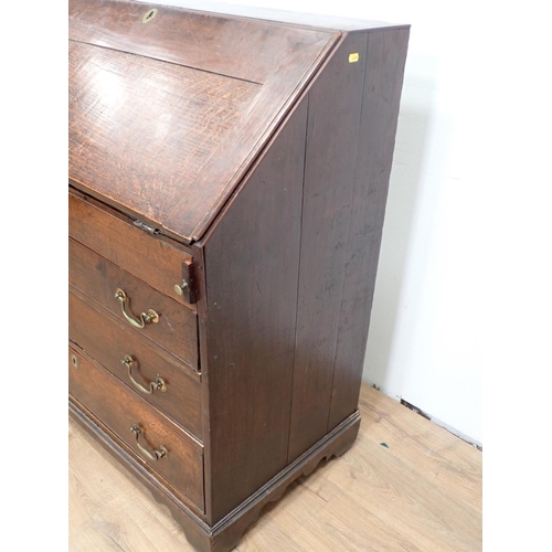 503 - An 18th Century oak Bureau, the interior fitted drawers, pigeon holes and well above three long draw... 