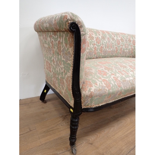 506 - An Edwardian and upholstered Settee with turned front supports and casters, 4ft 11in W