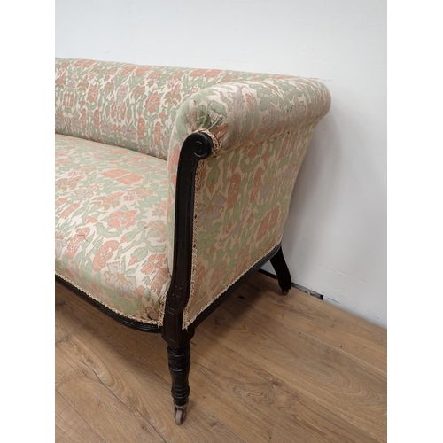 506 - An Edwardian and upholstered Settee with turned front supports and casters, 4ft 11in W