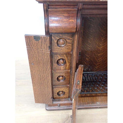 543 - A Singer Sewing Machine in oak Cabinet fitted hidden drawers 2ft 8in W x 2ft 8in H