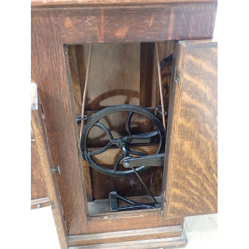 543 - A Singer Sewing Machine in oak Cabinet fitted hidden drawers 2ft 8in W x 2ft 8in H