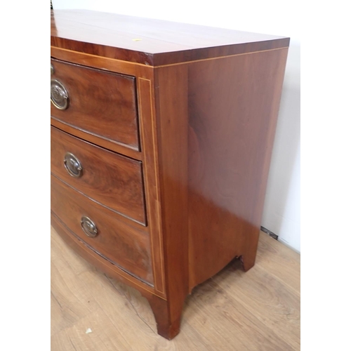 558 - A 19th Century mahogany and inlaid bow fronted Chest of two short and three long drawers on splayed ... 