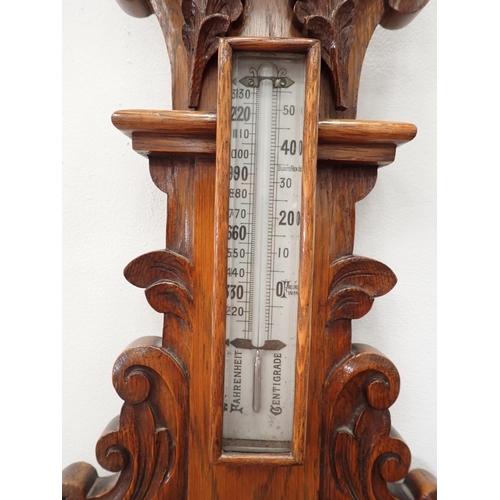 574 - A carved oak Aneroid Barometer