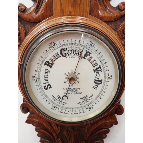 574 - A carved oak Aneroid Barometer