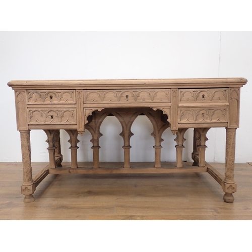 581 - A Gothic influenced oak Desk with arched tracery design fitted three frieze drawers 4ft 5in W x 2ft ... 