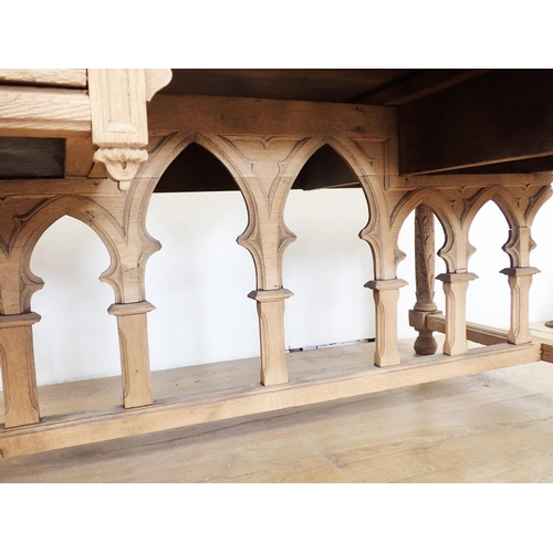 581 - A Gothic influenced oak Desk with arched tracery design fitted three frieze drawers 4ft 5in W x 2ft ... 