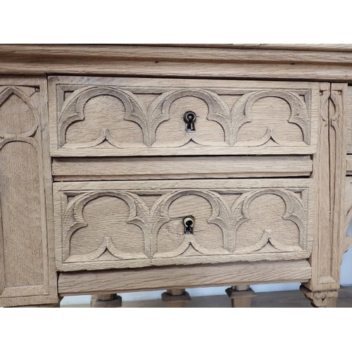 581 - A Gothic influenced oak Desk with arched tracery design fitted three frieze drawers 4ft 5in W x 2ft ... 