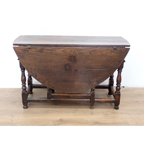 551 - An early 18th Century oak Gateleg Table fitted single end drawer mounted upon baluster turned suppor... 