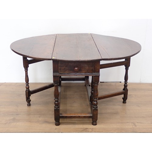 551 - An early 18th Century oak Gateleg Table fitted single end drawer mounted upon baluster turned suppor... 