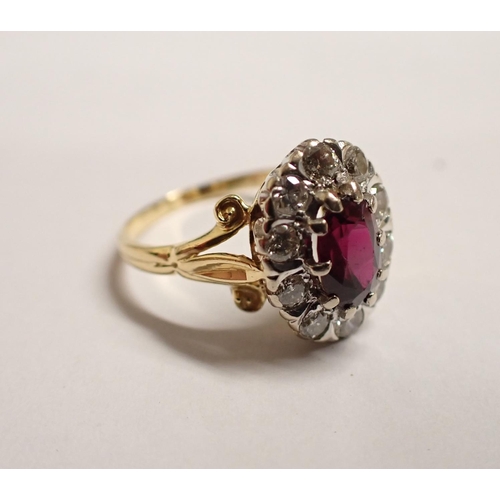 152 - A Ruby and Diamond Cluster Ring claw-set oval-cut ruby within frame of ten illusion-set brilliant-cu... 