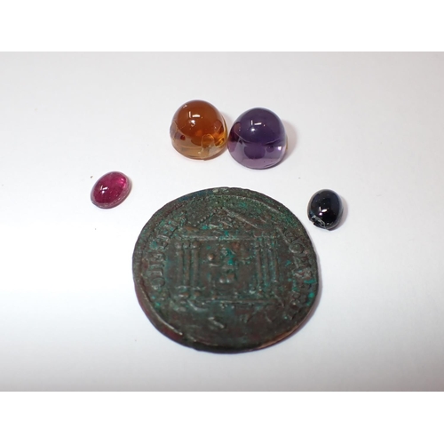 153 - Four unmounted Cabochons; ruby, sapphire, amethyst and citrine and a Roman Coin