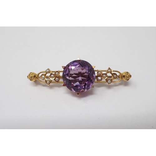 157 - An Amethyst and Seed Pearl Brooch claw-set round amethyst between groups of seed pearls