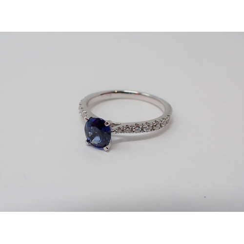 162 - A Sapphire and Diamond Ring claw-set oval-cut sapphire, 0.91ct, between graduated brilliant-cut diam... 