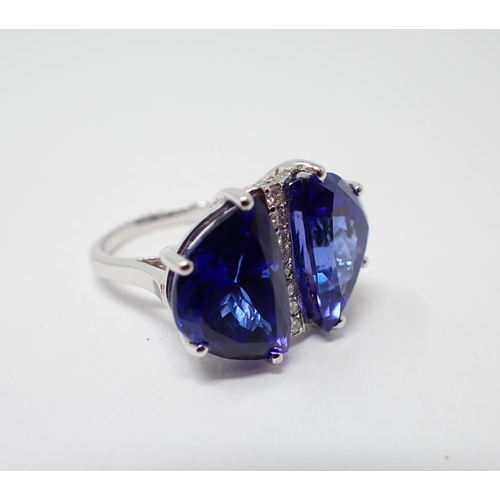 179 - A Tanzanite and Diamond Ring claw-set a pair of lunette-cut tanzanite, total weight 16.63cts, divide... 