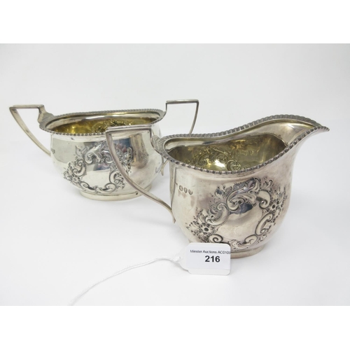 216 - A Victorian silver Sugar Bowl and Milk Jug with floral embossing, London 1891