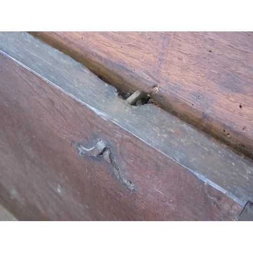 23 - A 17th Century oak six plank Sword Chest or Coffer on cupid's bow shaped end supports, the top with ... 