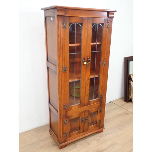 26 - An oak and lead glazed Bookcase fitted two linenfold cupboard doors to base 5ft 3in H x 2ft 5in W